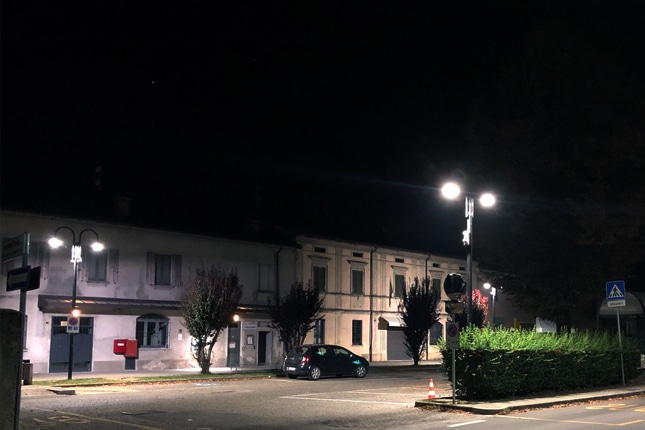 Round street light in a parking lot in Italy